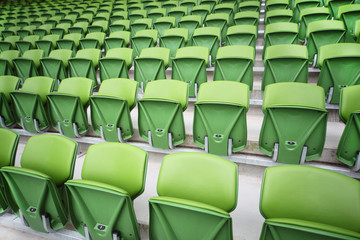 Obraz premium Rows of folded seats in empty stadium. Focus on front seats