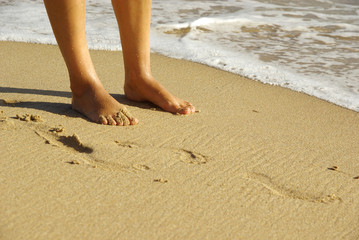 Fototapeta na wymiar Lady feet on a beach