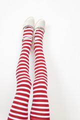 girl`s legs wearing white and red stokings
