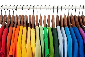 Fotobehang Rainbow colors, clothes on wooden hangers © Studio Light & Shade