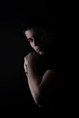 Fototapeta na wymiar portrait of a young man in the darkness