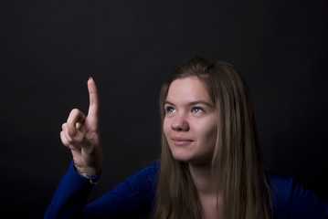 Portrait of a young girl pointing at something