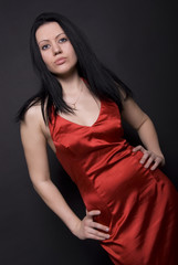 Portrait of a young brunette in red posing