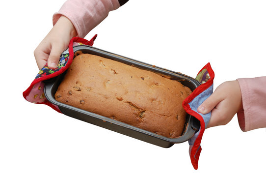 Child Hands Hold A Pan With Baked Cake