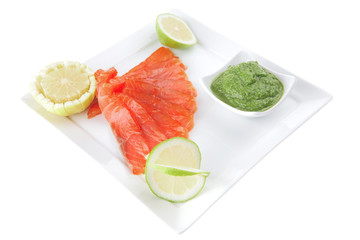green sauce and salmon with lemon