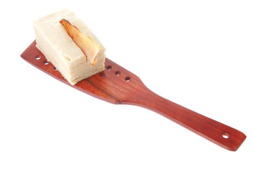 cream cake on wooden spatula
