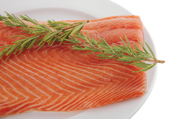 big salmon fillet on white with rosemary