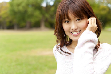 a young woman listening to music on the park