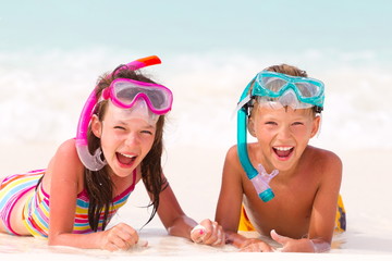 Happy boy and girl on beach