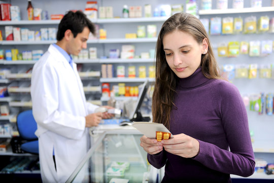 Consumer with medicine at pharmacy