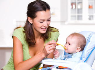 Obraz na płótnie Canvas Mother feeding hungry baby