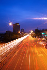 Fototapeta na wymiar city highway at night with light trails