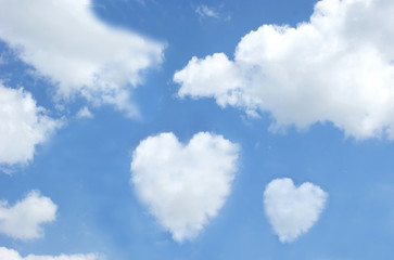 Naklejka na ściany i meble Heart shaped clouds in the sky