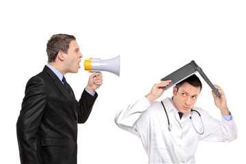 Angry businessman yelling via megaphone to a doctor