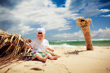 Cutte little boy relaxing on a beach