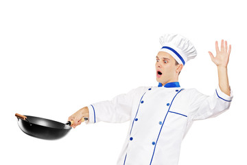 A surprised chef holding a wok