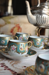 Tea time, with china and silver wear over living room table