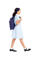 young school student walking to school on white