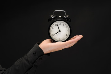 woman with an alarm clock in a hand.