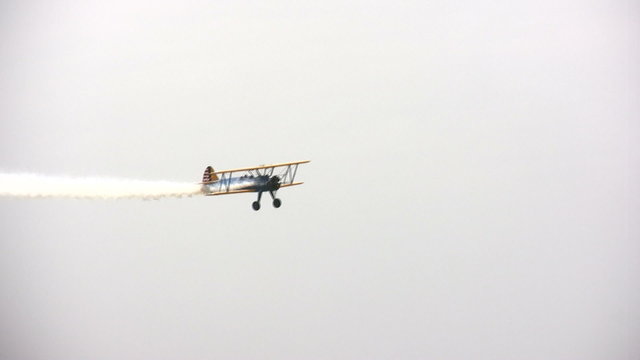 Old biplane performing aerial stunt