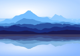 View of blue mountains with reflection in lake