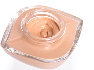 Poured beige toner cream isolated on white background