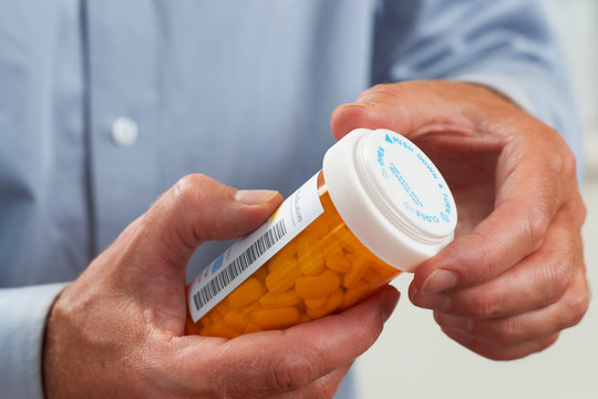 Close up of patient pouring out RX pills