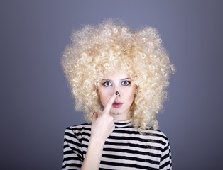 Portrait of funny girl in blonde wig.