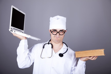 Young doctor with notebook and book.