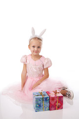 little girl in a pink dress with ears of a rabbit on a head