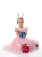 little girl in a pink dress with ears of a rabbit on a head