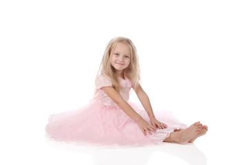 Fototapeta premium little girl in a pink elegant dress.White background