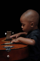 african american boy play guitar