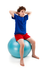 Fototapeta na wymiar Active boy exercising on white background