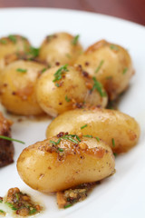 Roasted baby potatoes with onion, mustard seed and chives