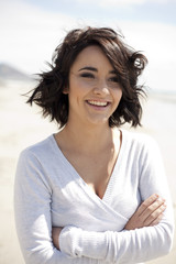 Gorgeous brunette smiling at the beach