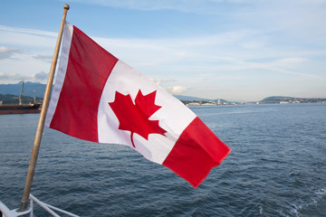 Canadian flag over a bay