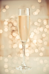 Glass of champagne against golden background