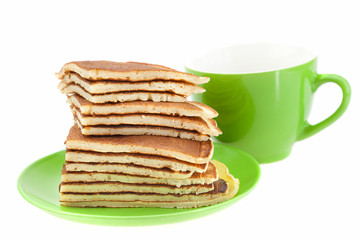 Pancakes on a plate and cup isolated on white