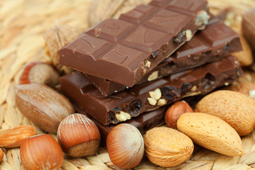 bar of chocolate and nuts on a wicker mat