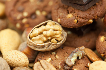 oatmeal cookies, chocolate and nuts on a wicker mat