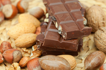 bar of chocolate and nuts on a wicker mat