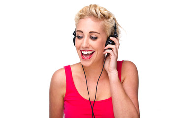 Naklejka premium Young woman listening to music with headphones looking away