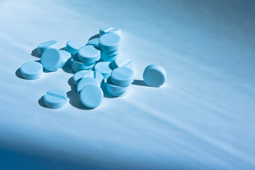 Some pills on blue background