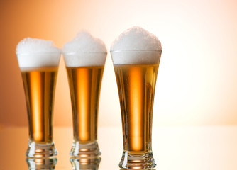 Beer glasses against the colorful gradient background