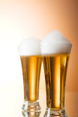 Beer glasses against the colorful gradient background