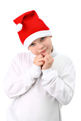 Small boy in Santa's red hat isolated on white