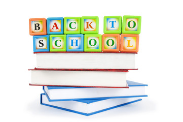 Books and alphabet blocks isolated on white