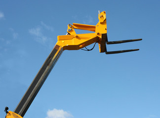 The Top of a High Lift Yellow Hydraulic Fork Lift Truck.