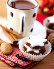 Cinnamon stars and hot chocolate with cinnamon sticks